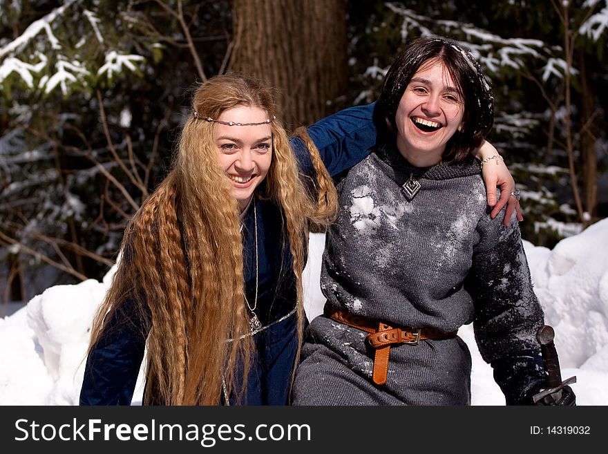 Two ladies in medieval dresses in winter forest. Two ladies in medieval dresses in winter forest