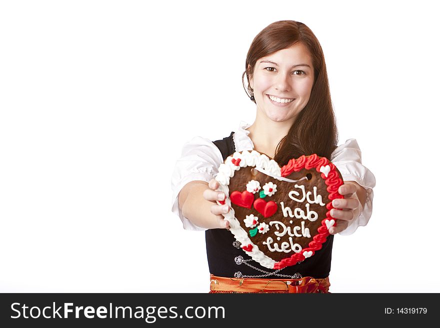 Bavarian woman in love holds Oktoberfest gingerbread heart. Isolated on white background. Bavarian woman in love holds Oktoberfest gingerbread heart. Isolated on white background.