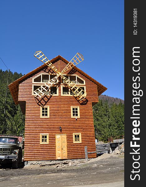 Wooden mill on a background dark blue sky