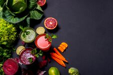 Different Healthy Vegan Drinks With Fruits And Vegetables On The Black Wooden Background. Flat Lay Royalty Free Stock Images