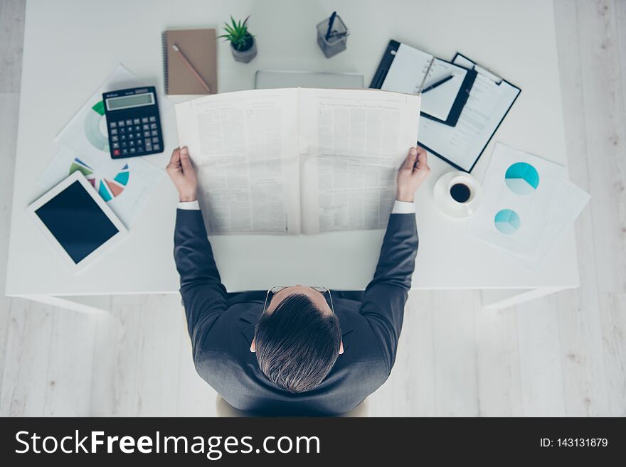 High angle above top view calm confident trendy style stylish imposing elegant classy chic man in formalwear sit behind desktop in bright lite office read column newspaper.