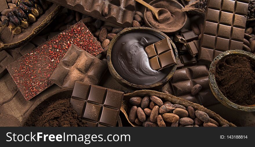 Cocoa Beans And Chocolate On Natural Paper Background