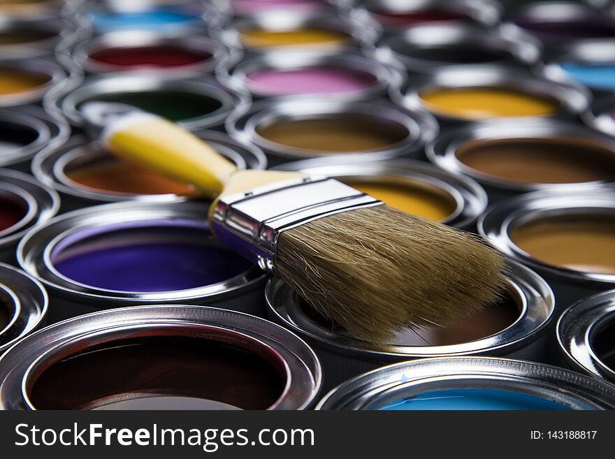 Tin cans with paint, brushes and bright palette of colors. Tin cans with paint, brushes and bright palette of colors