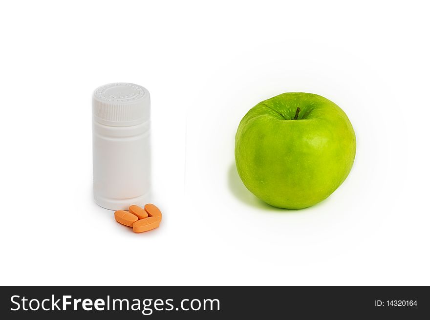 Concept of different vitamin sources - ripe apple or bottle of pills