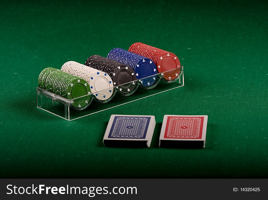 Casino gambling chips on green table. Casino gambling chips on green table