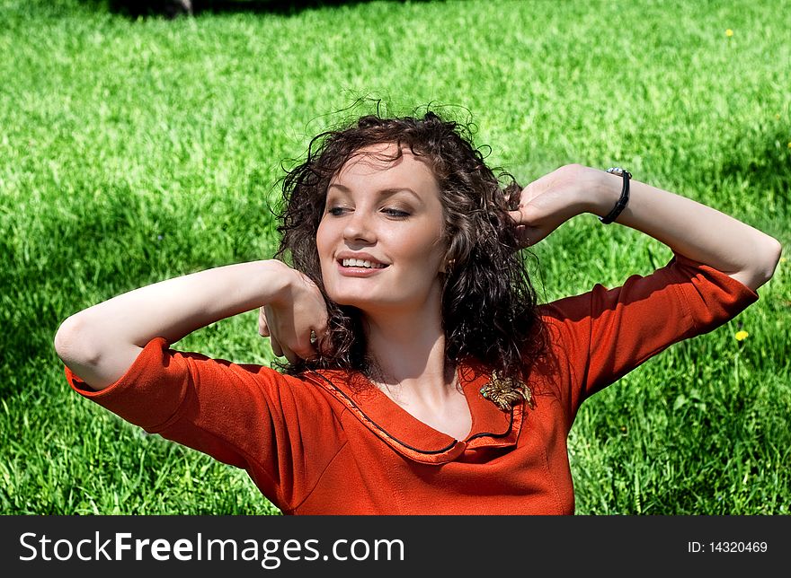 Young woman stretches in a grass