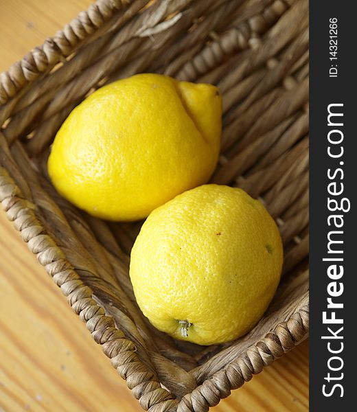 Two lemons in a basket on the table