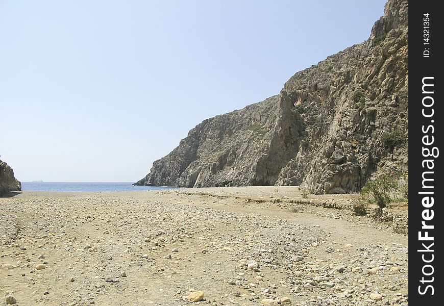 Deserted beach in a bay in Crete