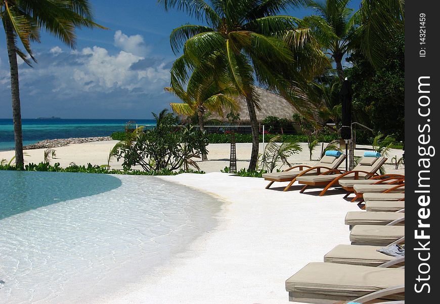 Beach beds near swimming pool. Beach beds near swimming pool.