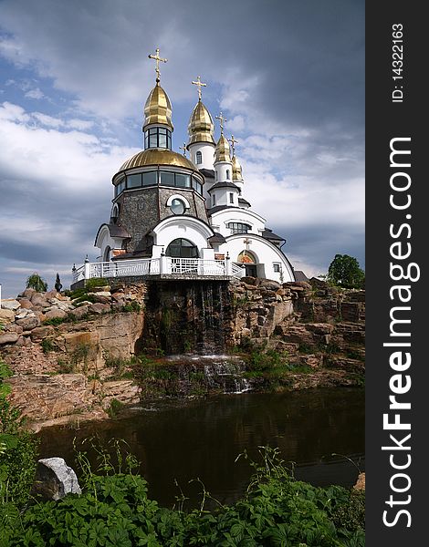 Gold-domed church under cloudy sky