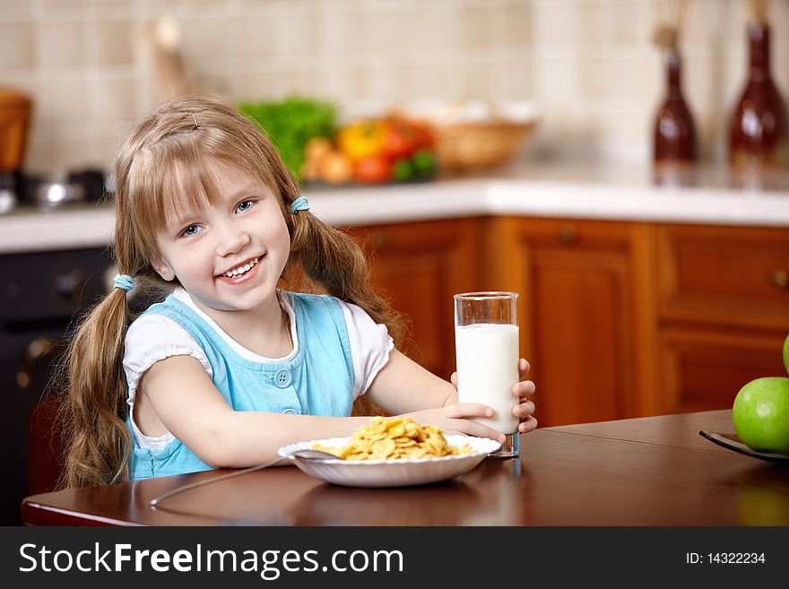 The little girl has breakfast on kitchen. The little girl has breakfast on kitchen