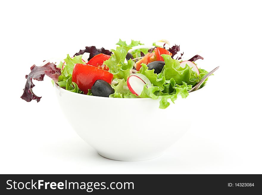 Fresh salad in a white bowl on a white background