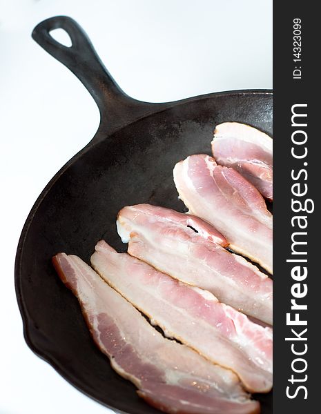 Uncooked Bacon Strips on Skillet. Uncooked Bacon Strips on Skillet