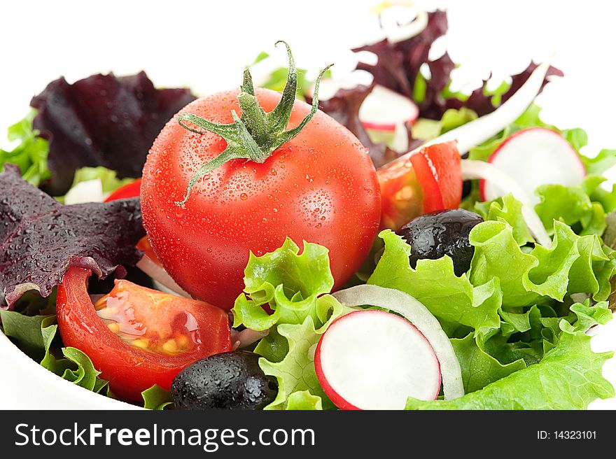 Fresh salad in a white bowl on a white background