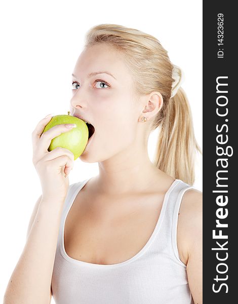 Young blonde is eating apple isolated on white. Young blonde is eating apple isolated on white.