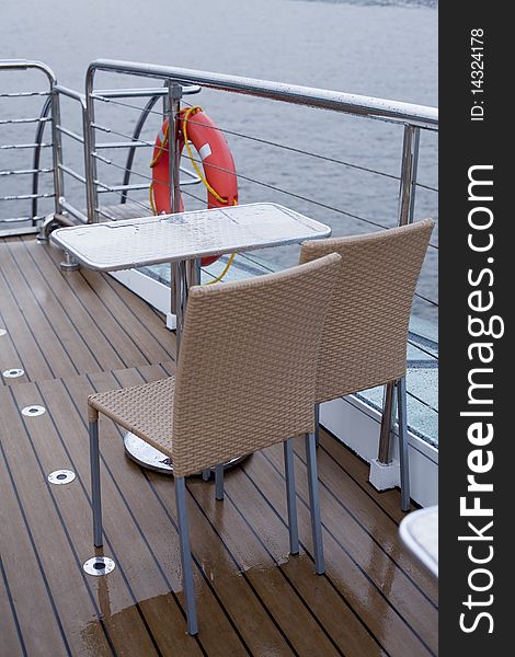Table and two chairs on the deck of a cruise ship. Table and two chairs on the deck of a cruise ship