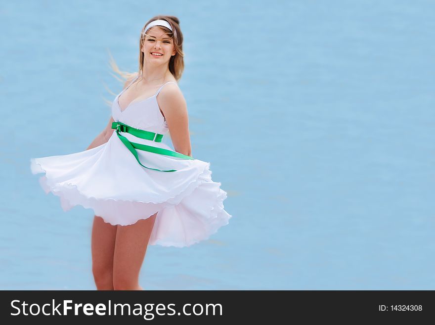 Young happy girl on sea background