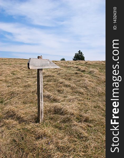 Direction sign for hikers on mountain path