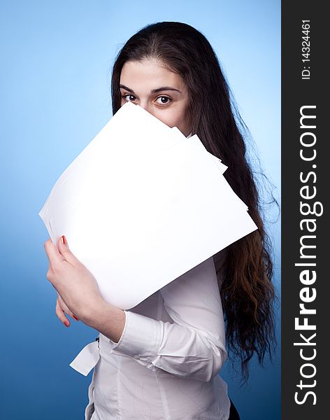 Businesswoman with documents on blue background