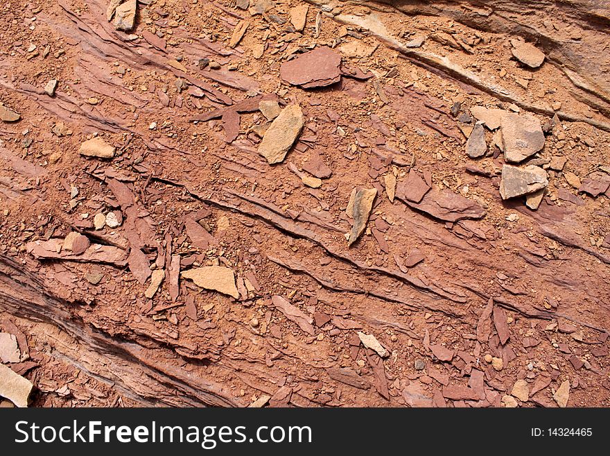 Close up of rocks on a red sandstone layer of rock. Close up of rocks on a red sandstone layer of rock.