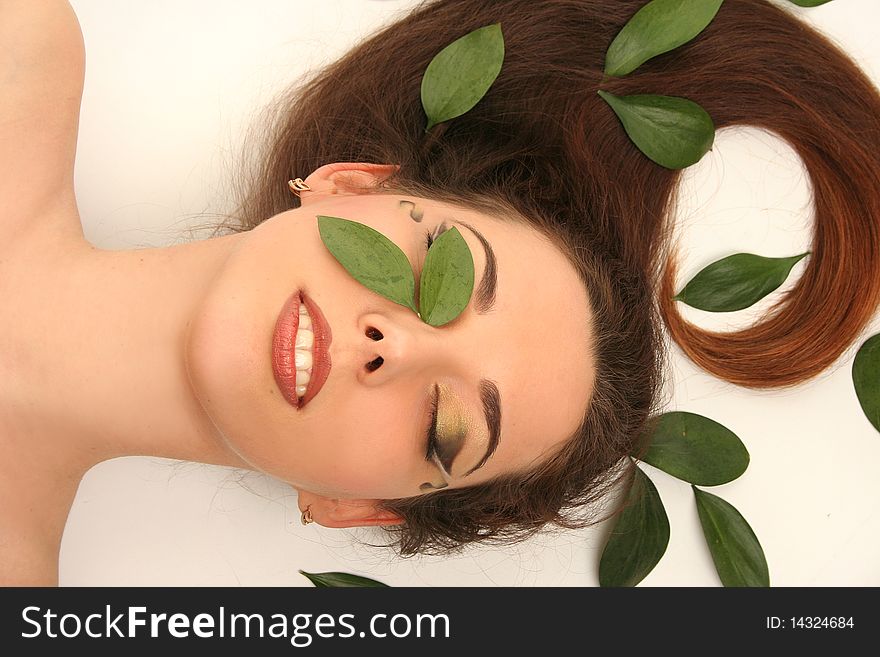 Beautiful young woman with green leaves. Beautiful young woman with green leaves