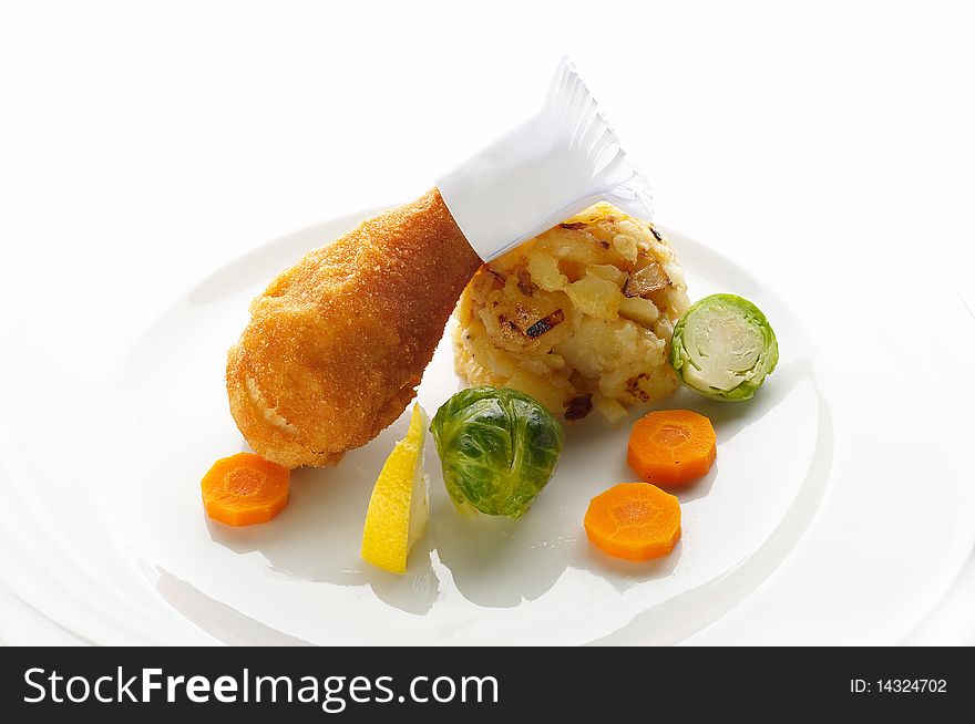 Fried chicken leg with mashed potato and vegetable