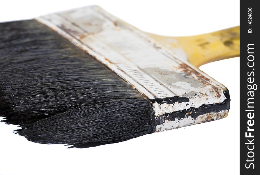 Dirty brush, covered by dry black paint, isolated