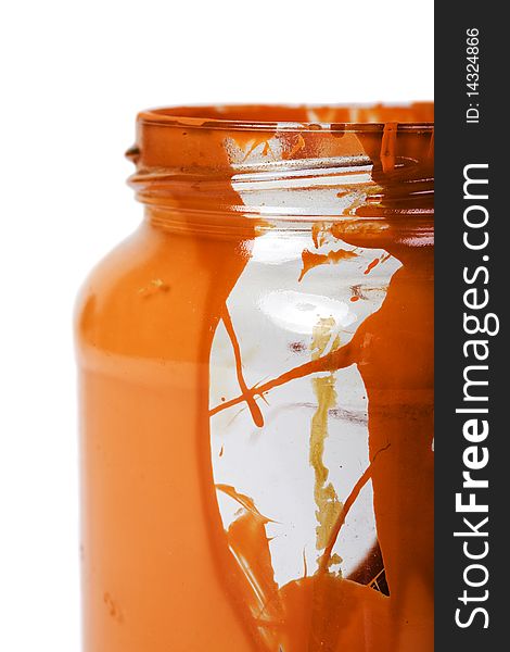 Empty glass jar with dried colored liquid close up