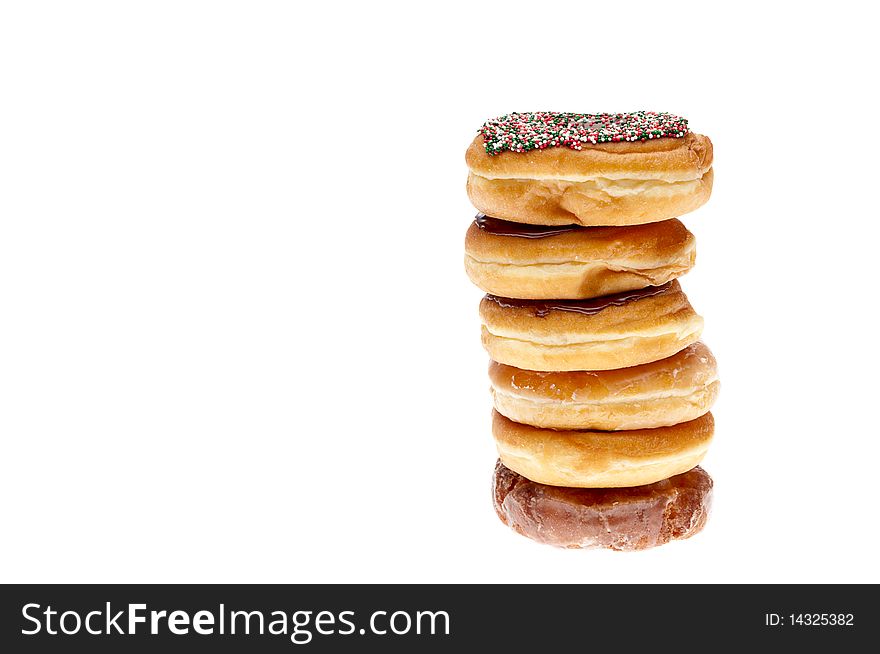 Horizontal image of a stack of fresh donuts isolated on white