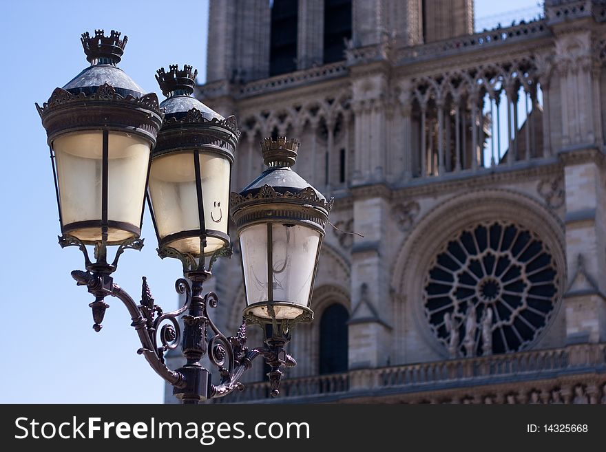 Streetlight with smiling face with Notre dame cathedral in background. Streetlight with smiling face with Notre dame cathedral in background