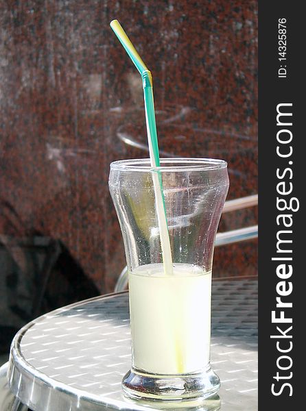 Close up view of a Lemonade glass in a terrace zinc table. Close up view of a Lemonade glass in a terrace zinc table