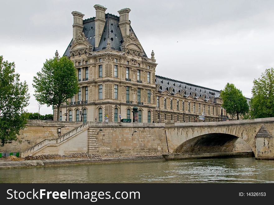 This shot of the Louvre Museum was taken from the Seine River on an overcast day. This shot of the Louvre Museum was taken from the Seine River on an overcast day.