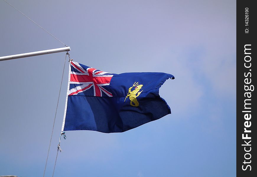 Blue ensign flag with motif flying in the wind