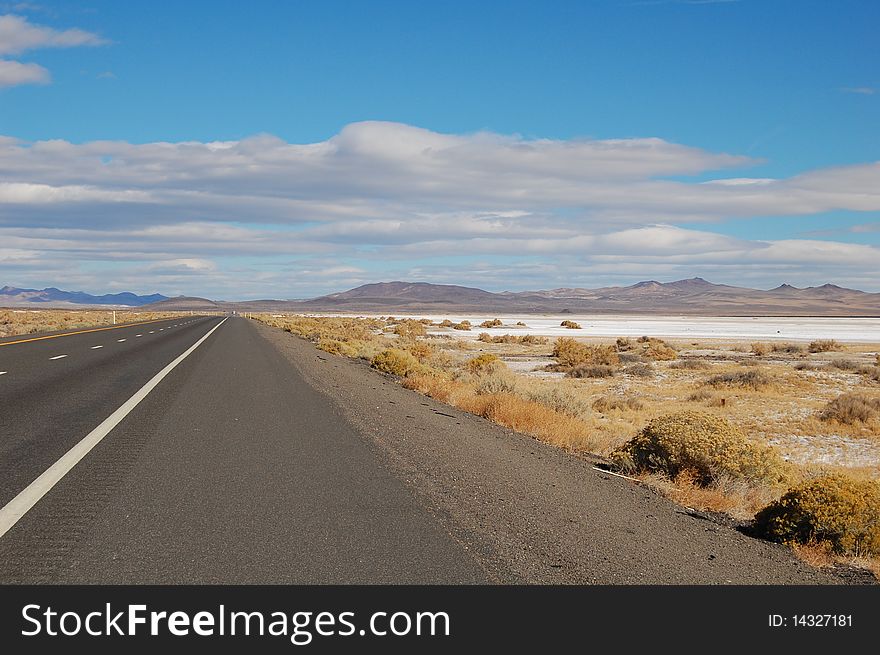 Highway in nevada with desiccation and blue skies. Highway in nevada with desiccation and blue skies