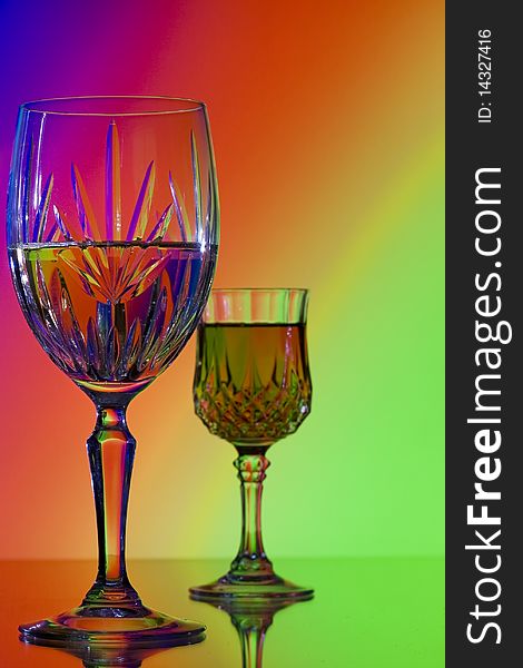 Two wine glasses on bright colorful rainbow background. Two wine glasses on bright colorful rainbow background