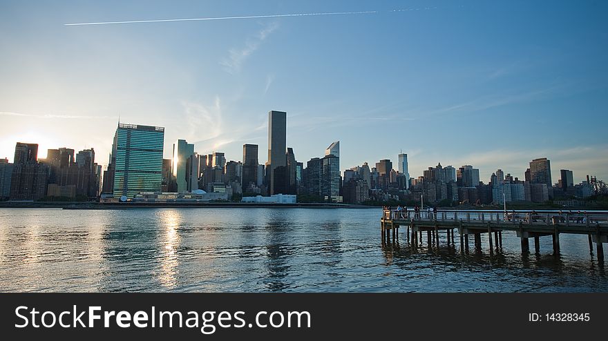 The Manhattan city skyline as viewed from Long Island over the East River at dusk. The Manhattan city skyline as viewed from Long Island over the East River at dusk.