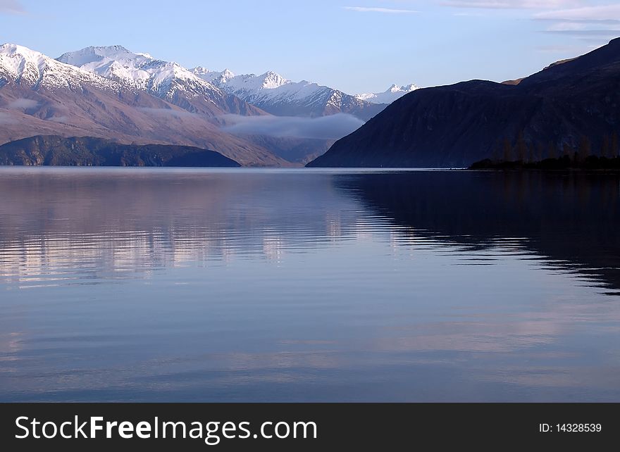 Spectacular Lake Wanaka, New Zealand with early morning mist.