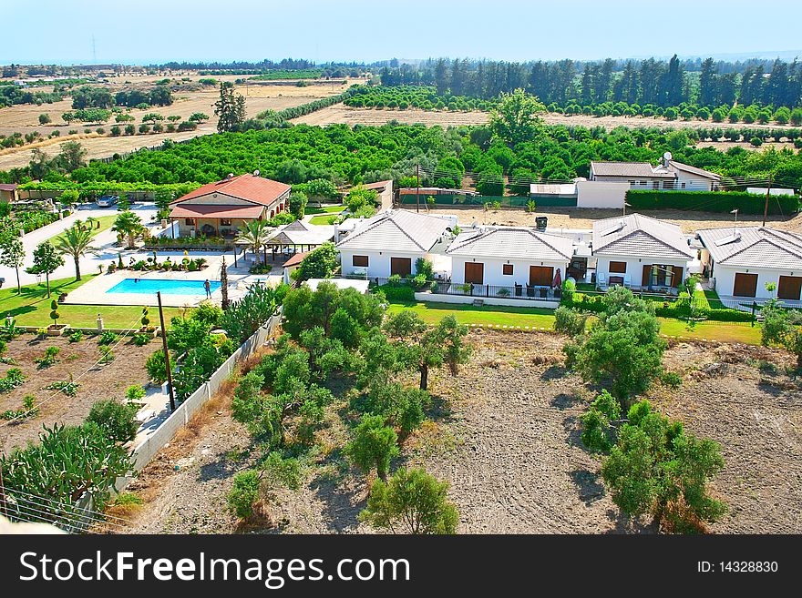 Cyprus rural landscape with houses,gardens and swimming pool.