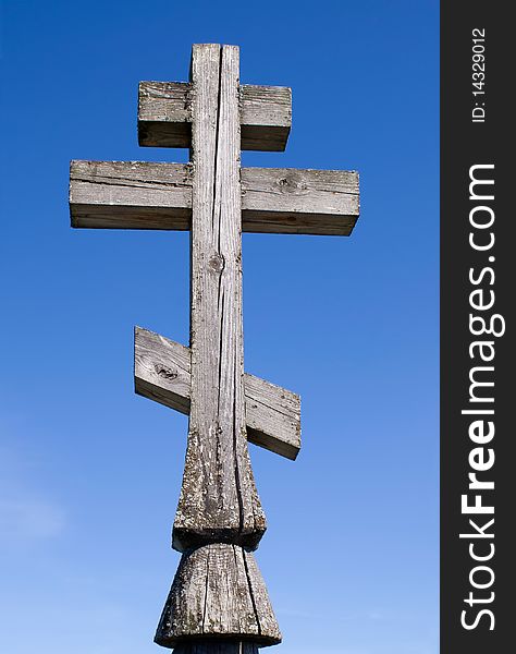 Wooden church cross on a blue sky background