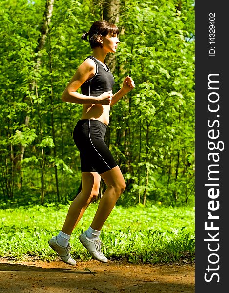 Young woman running in forest. Young woman running in forest