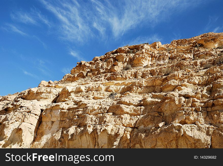 Ancient rocks under blue sky. Desert Negev, Israel.