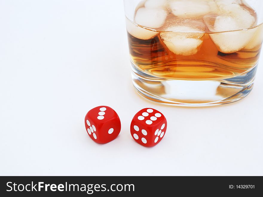 Glass of whiskey with ice cubes and dices. Glass of whiskey with ice cubes and dices.
