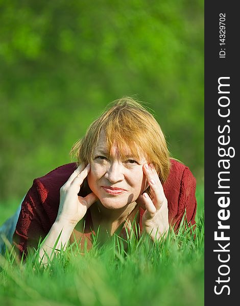 Smiling senior woman  in a spring  meadow