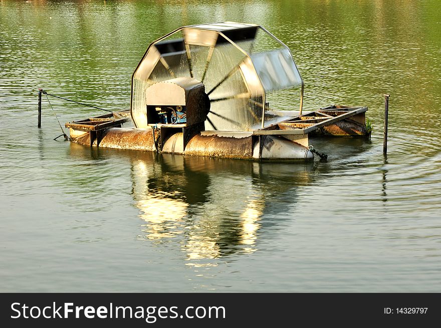 Working water wheel in public park. Working water wheel in public park.