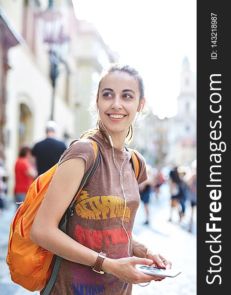 A woman tourist in the center of Prague with a phone in the hands of