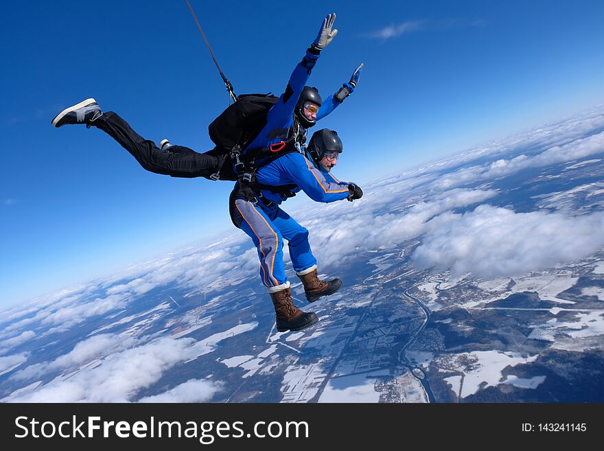 Tandem Skydiving. Two Guys Are In The Blue Sky.