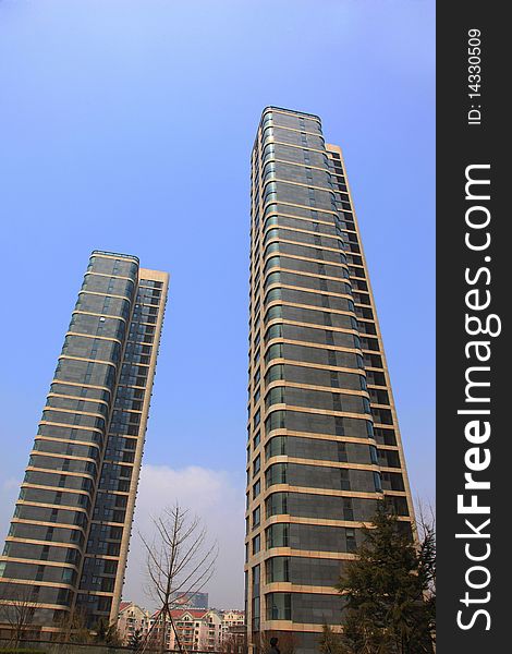 Two business buildings against  blue sky. Two business buildings against  blue sky.