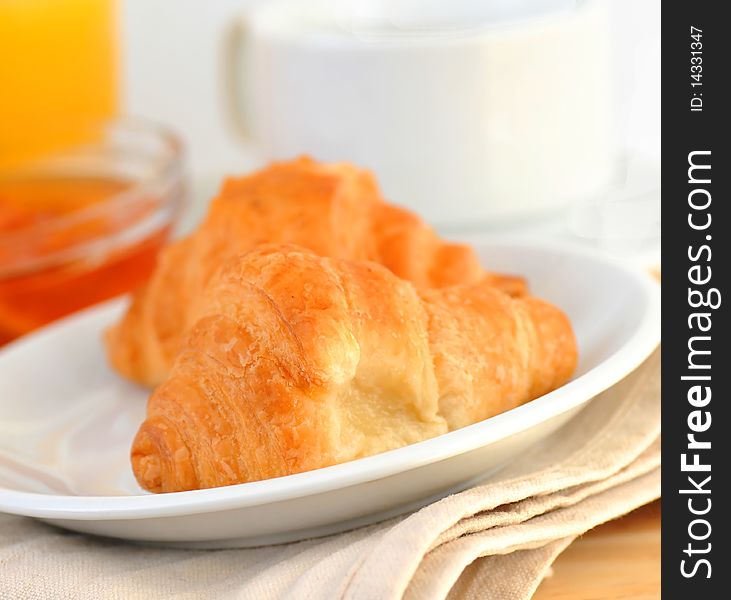 Continental breakfast - croissant, coffee, jam and orange juice