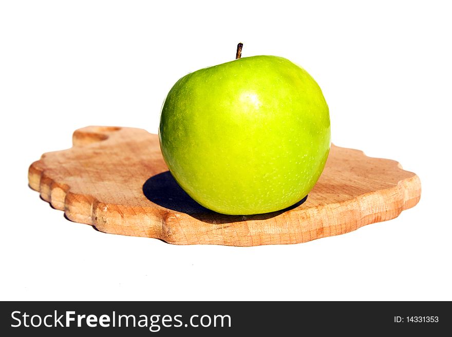 Green apple on a chopping board