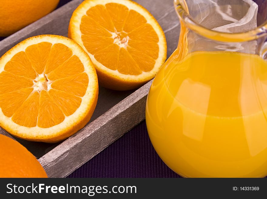 Sliced oranges and orange juice in carafe with oranges